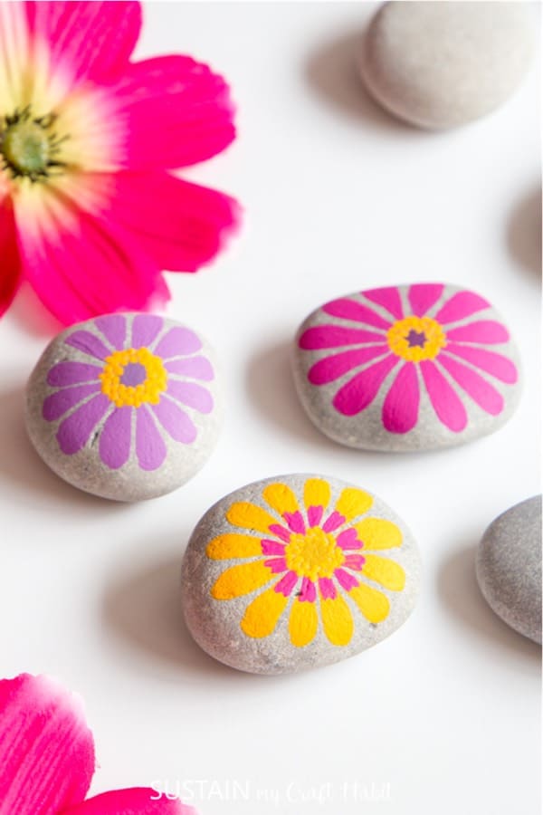 painted rocks with flower pattern